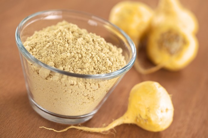 Maca-powder-flour-in-glass-bowl-with-maca-roots-or-Peruvian-ginseng-lat.-Lepidium-meyenii